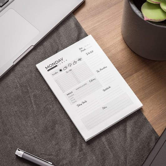 Daily planner notepad: A notepad designed for daily use to keep track of to-dos and goals.